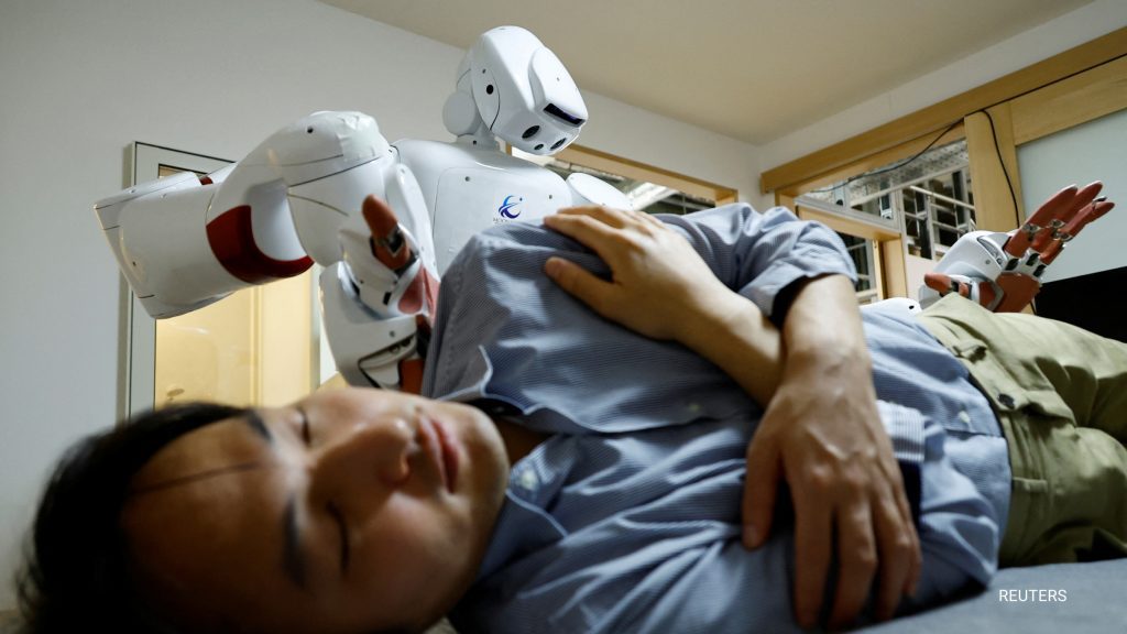 Recently in Tokyo an AI-driven robot leaned over a man lying on his back and gently put a hand on his knee and another on a shoulder.