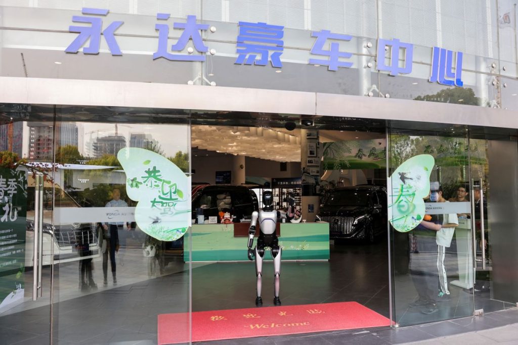 In a sprawling warehouse in a Shanghai suburb, dozens of humanoid robots are maneuvered by their operators to carry out tasks